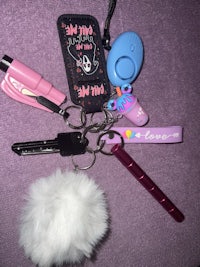 a bunch of keychains with a pink furry pom pom